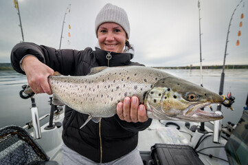Women angler with a big lake trout