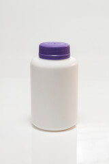 white plastic bottle with purple lid on white background