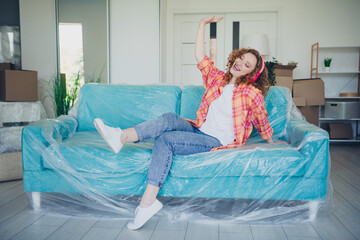 Photo of cheerful positive cute woman buy new flat apartment comfy living room listen audio song...