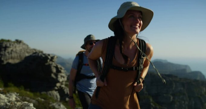 Mountains, outdoor woman and hiking couple of friends journey, wellness tour and backpacking on Australia hill. Cliff rocks, blue sky and people walking with freedom adventure and explore nature
