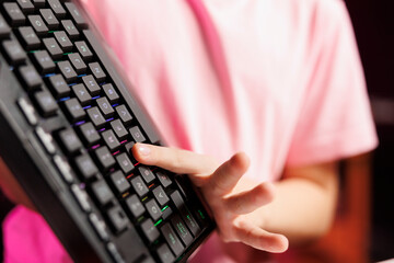 Close up on mechanical keyboard received by cute girl from sponsoring brand to promote it. Focus on...