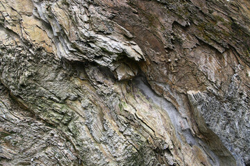 Layered rock formations with intricate stone textures, revealing the mountain's geological history. The abstract patterns create a textured background, highlighting the complexity of rock layers.