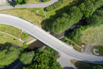 Reinforced concrete road bridge over the river. Close-up during sunny day in summer. Aerial view on...