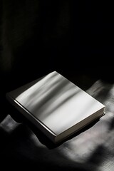 A tightly framed shot of a white book on a dark backdrop with dramatic chiaroscuro lighting  AI generated illustration