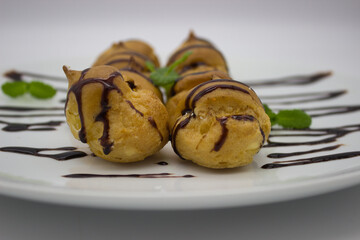 Close-Up of Profiteroles with Chocolate Drizzle