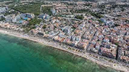 Platja de Palma, Spain-8-20-24,  panoramic aerial beach overview of coastline in Playa de Palma at Bay of Palma with village and hotels building along the coast and overcrowded beach area © Mario Hagen