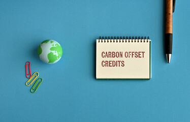 There is notebook with the word Carbon Offset Credits. It is as an eye-catching image.