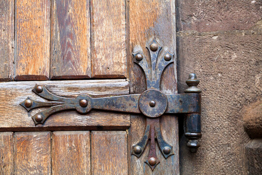 Europe, Romania. Brasov. Detail of church exterior. Wood door hinge.