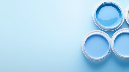 Three blue paint cans are arranged in a row on a blue background