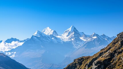 Majestic mountain range with snow-capped peaks and clear blue sky above. Majestic Mountain Range