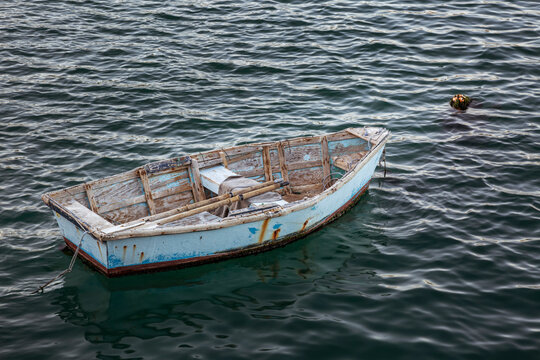 USA, California, Central Coast, Avila Beach. Rustic dinghy moored at Harford Pier