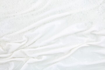 Obraz premium Washing laundry in water with foam, top view