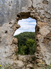 A hole in the wall of an old church on Cape Asprokavos on the Island of Corfu in Greece.
