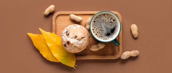 Composition with cup of aromatic coffee, muffin and peanuts on color background