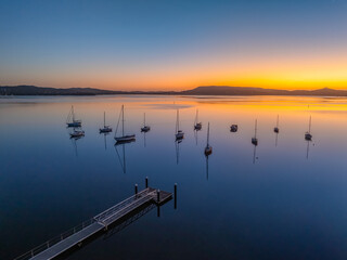 Aerial drone sunrise waterscape over the bay and boats