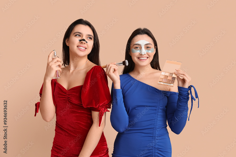 Poster beautiful young women in stylish dresses with facial masks and cosmetics on color background