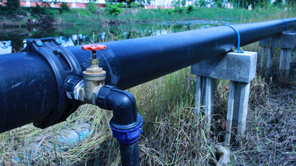 Water valve on hdpe pipe. Water shut-off valve at Saddle Clamp connection point to supply water to...
