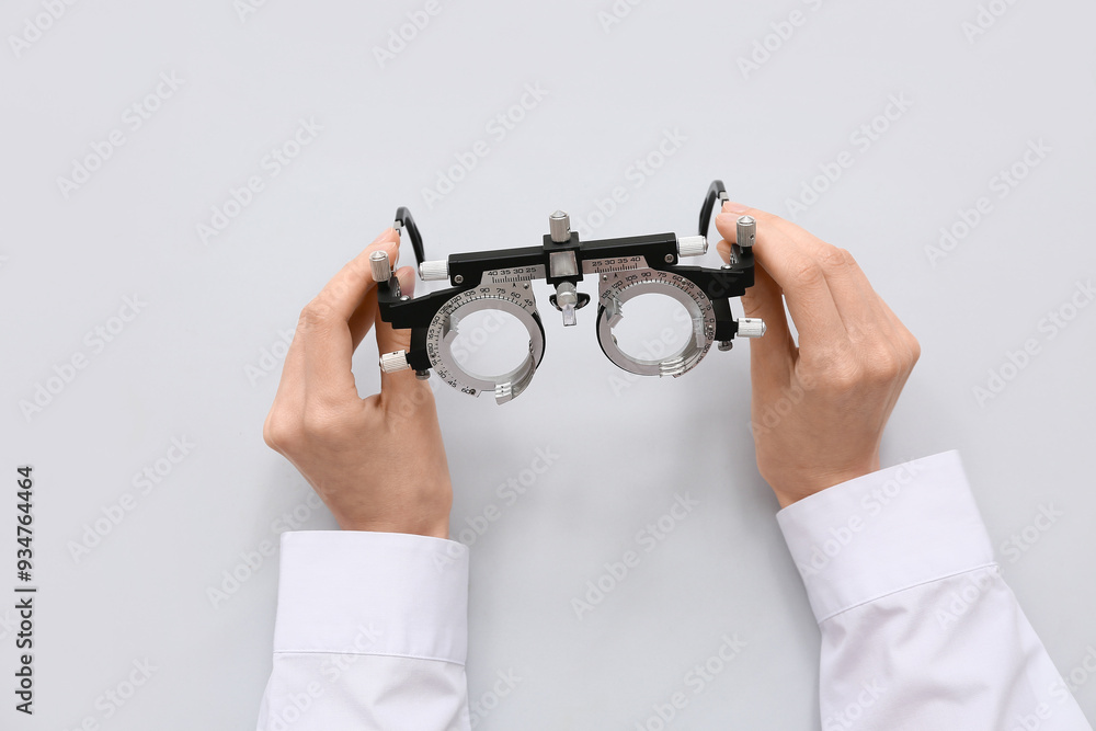 Poster doctor hands with optical trial frame on white background