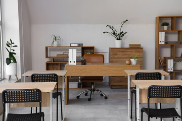 Interior of stylish empty classroom with chairs and desk