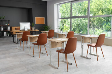 Interior of modern stylish empty classroom prepared for exam
