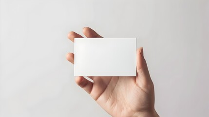 Blank White Credit Card on Woman's Hand Holding Skincare Product Package on Minimal Background