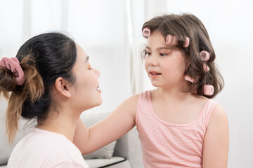 Happy children makeup and make hair styles for mother. Girl applying makeup. Advertisement, lifestyle , cosmetics, makeup accessories, beauty activity, beautician, talent, love beauty