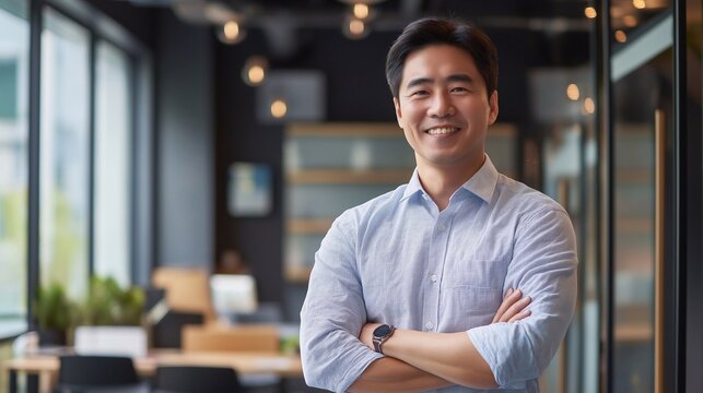 Happy confident professional Korean business man of mature standing in office. 40 years old business owner, company manager, smiling senior ceo executive, corporate leader at work.