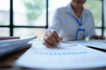 woman plans a finance and budget audit by reviewing organizing office financial documents