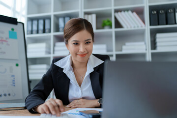 woman meticulously plans a finance audit, using a computer and calculator to review budget...