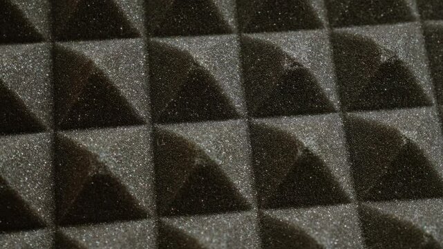Closeup of grey acoustic foam texture pattern used for soundproofing and studio setup providing noise reduction and echo control