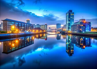 Fototapeta premium ethereal nighttime shot of glasgow harbour with reflections of city lights and calm waters in cool blue hues and misty atmosphere
