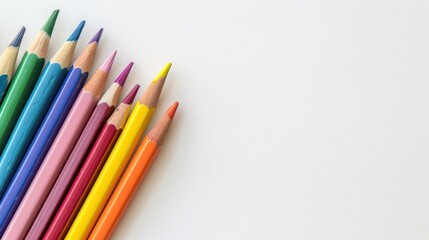 Fototapeta premium Close-up of beautifully arranged colorful colored pencils. White background with copy space.