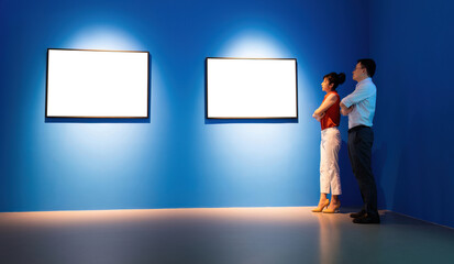 Businessman and businesswoman looking blank pictures