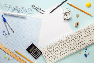 The student engineer's accessories - compass,  drawing,  pencil on  blue background. Top View. International Students' Day
