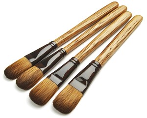 Fototapeta premium Four wooden handled brushes.
