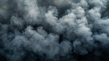 Fototapeta premium Close-up of thick, gray smoke pouring out from an industrial exhaust, with an emphasis on the dense, billowing texture