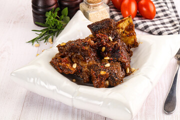 Prepared tasty beef ribs with sauce