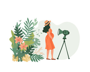 The pregnant woman films a video blog in front of a video camera in nature