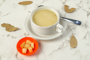 Creamy Soup in White Bowl with Crispy Bread