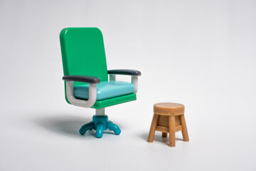 Fototapeta premium Green Office Chair and Stool on a White Background