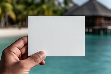 Blank postcard in a traveler's hand, exotic destination in the background