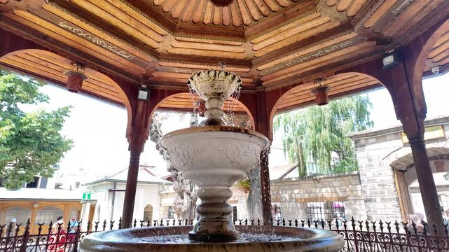 Slow motion of an Islamic fountain and a bird in the courtyard of the Gazi Husrev Bey's Madrasa in Sarajevo, Bosnia Herzegovina.