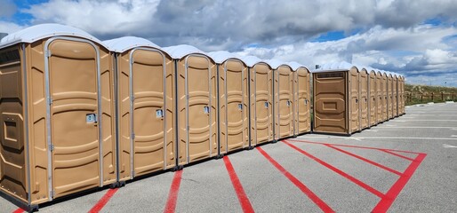 Brown porta potty lined up in a row 