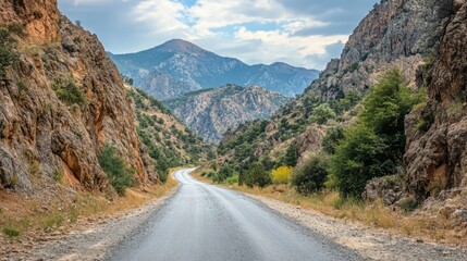 Fototapeta premium photo of a narrow asphalt road in a mountainous area.