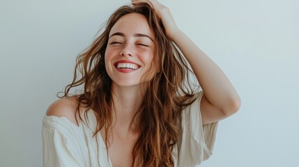 Fototapeta premium Freckles and waves, woman with unruly hair laughing.