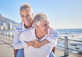 Portrait, piggyback and mature couple in beach, nature and bonding in vacation for fresh air and...