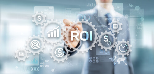 ROI Return on investment reading revenue business concept on virtual screen.