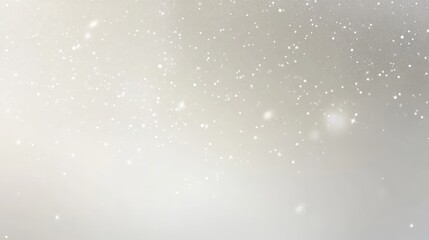 A soft, blurred background with floating particles resembling snow or glitter.