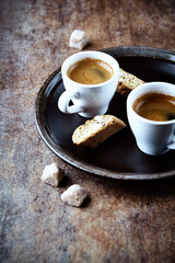 Two Cups Of Coffee on rustic stone background.
