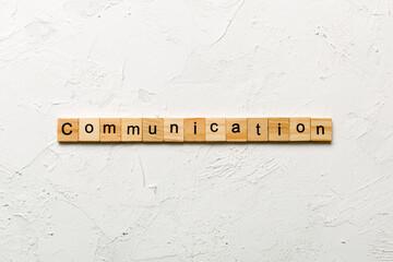 COMMUNICATION word written on wood block. COMMUNICATION text on cement table for your desing,...